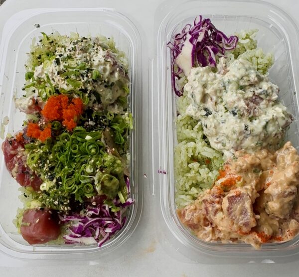 Two fresh poke bowls from Off the Hook in Mānoa, Oʻahu featuring ahi tuna and toppings in takeout containers
